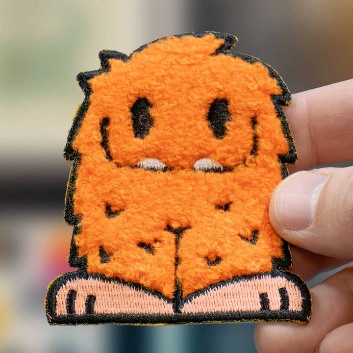 Reggie Fluffy Orange Monster Iron-On Patch for wholesale by Hi, Hello There