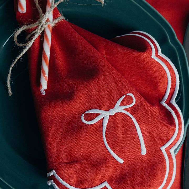 Red Rosie Scallop Placemat with bow for wholesale on Faire2