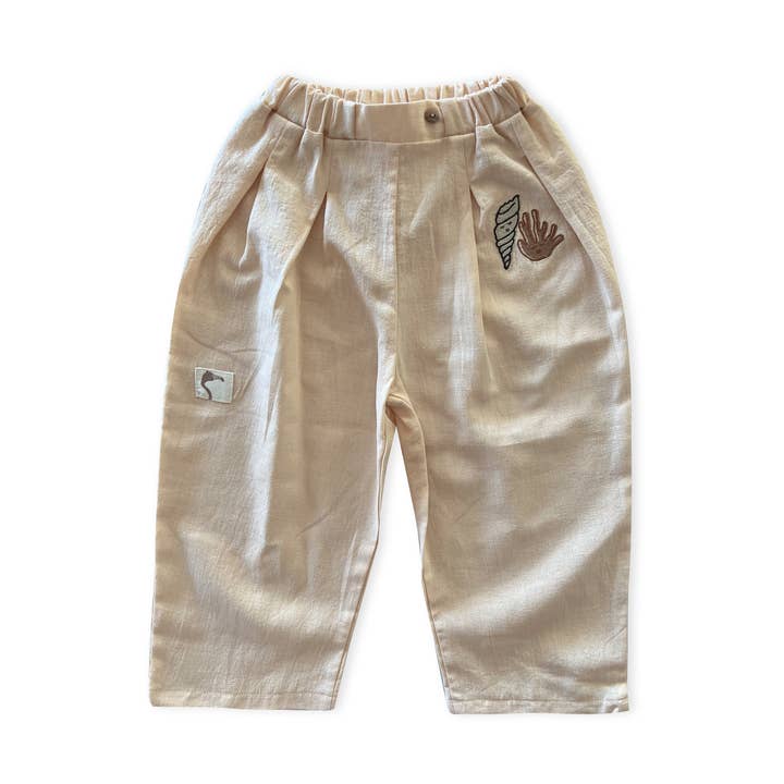 Ivory Cream ’Shell And Coral’ Pleated Woven Trousers for wholesale by AUNTIE ME