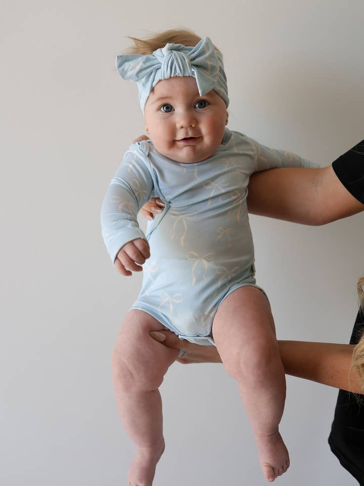 Tutina in bambù a maniche lunghe con bottoni automatici | Fiocchi blu per la vendita all'ingrosso da parte di Forever French Baby