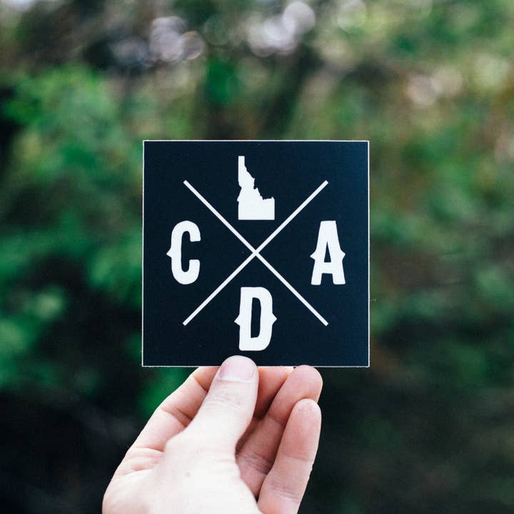 Bold CDA Idaho Logo Square Sticker for wholesale by IdaWholesale