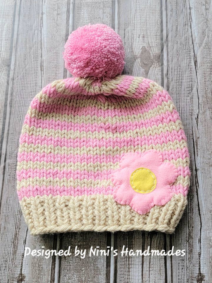 Hand Knit Beige and Rose striped Pom Pom Hat with Flower for wholesale by Nini's Handmades