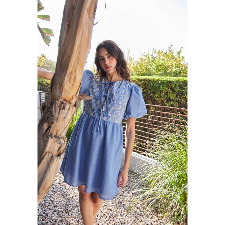 CHAMBRAY EYELET BUST MINI DRESS WITH FRONT BOW TIE DETAIL for wholesale on Faire