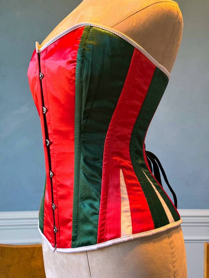 Red and green satin with white Santa Christmas satin corset. Corset is made personally according to your measurements. for wholesale by corsettery