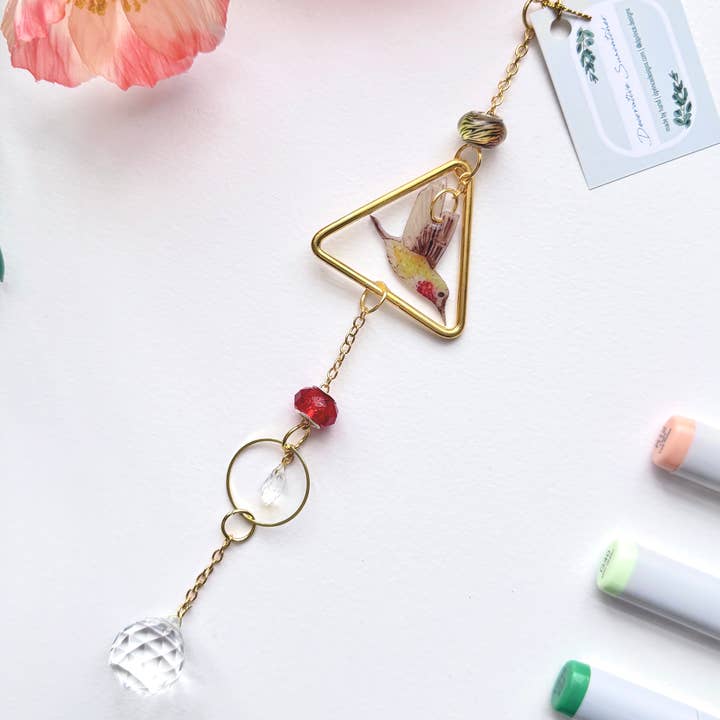Handmade + Hand-Illustrated Hummingbird Suncatcher with Green and Red Beads for wholesale by D. Prince Designs