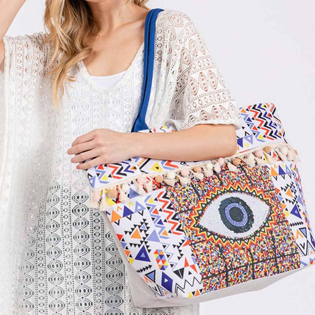 MT  EVIL EYE BOHO PRINT POM POM FRINGE TOTE BAG for wholesale on Faire2