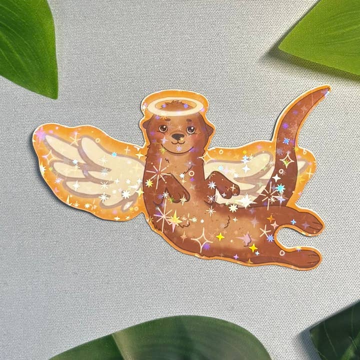 Otter Angel Sticker: Glossy Star Holo Laminate Vinyl Decal for wholesale by MysticalToastArt