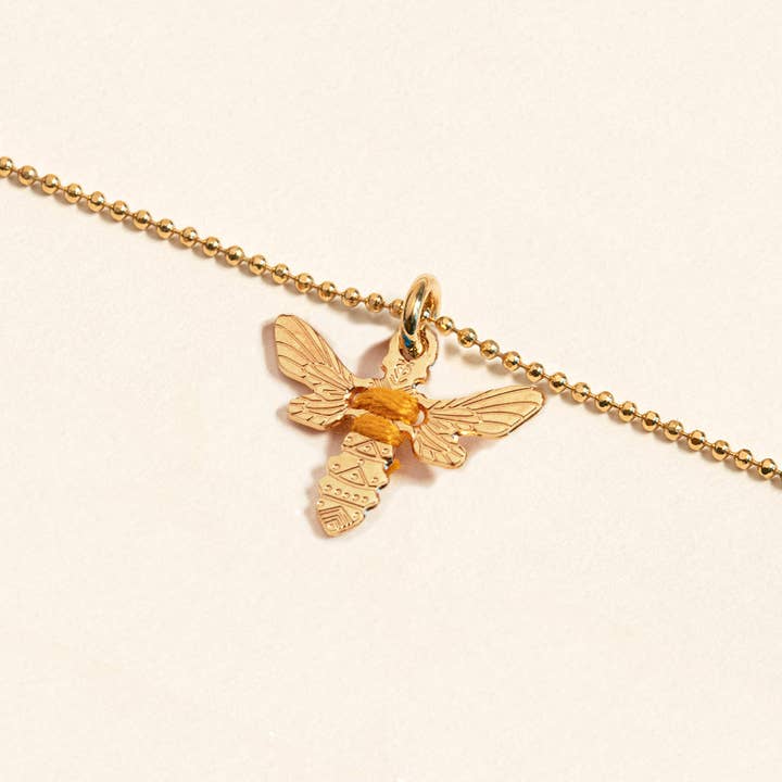 Amulet gold bee pendant to wear on a chain for wholesale by CAMILLE ENRICO