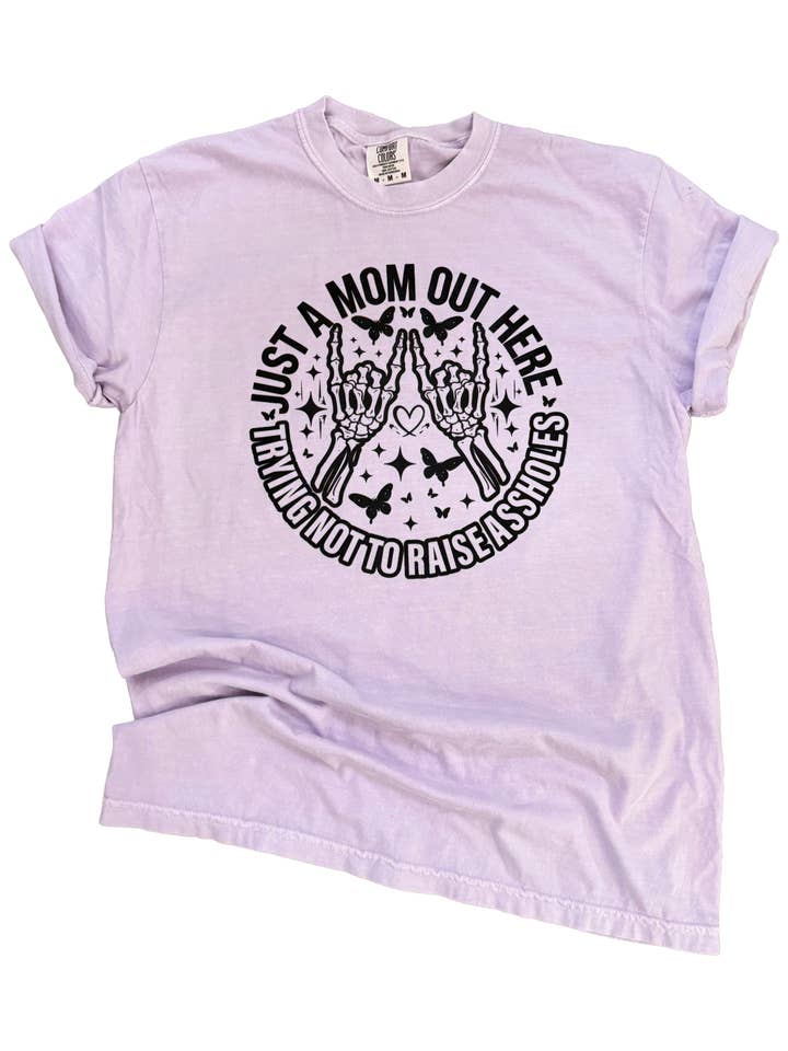 Just a Mom Out Here Trying Not To Raise A**holes- Mom Life Tee for wholesale by Pick Your Poison Tees LLC (Formerly Wandering Owl Designs)