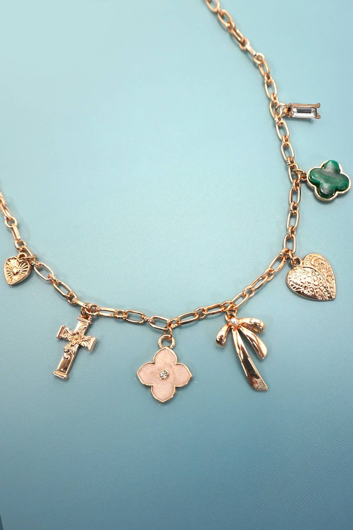 GOLD CHARM NECKLACE-GREEN CLOVER BOW CROSS HEART | 80N91991 for wholesale on Faire2