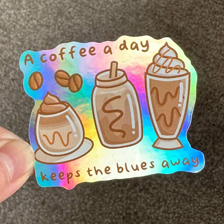 A coffee a day keeps the blues away Holographic Die Cut Sticker for wholesale by Cute Stickers Only