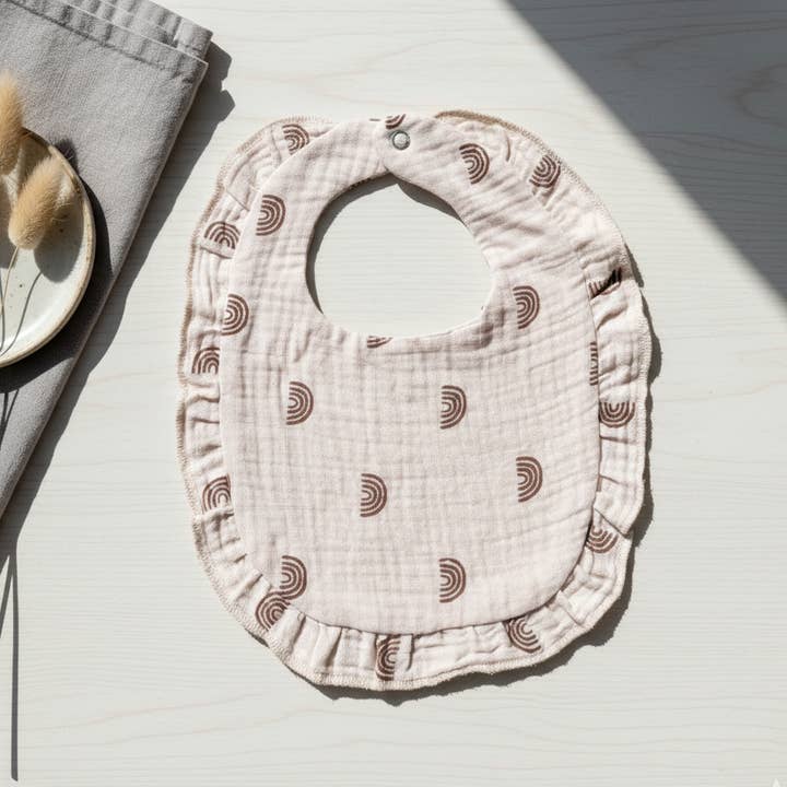 Soft hydrophilic bib with ruffles and cute rainbow print for wholesale by Rammelaartje