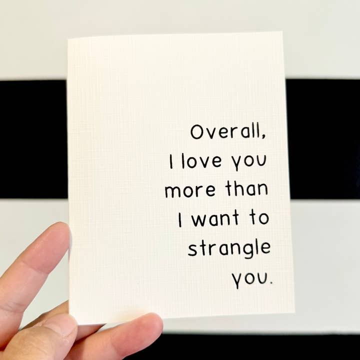 "Overall, I love you more than I want to strangle you." Quoted. Greeting Card for wholesale by AMW the studio