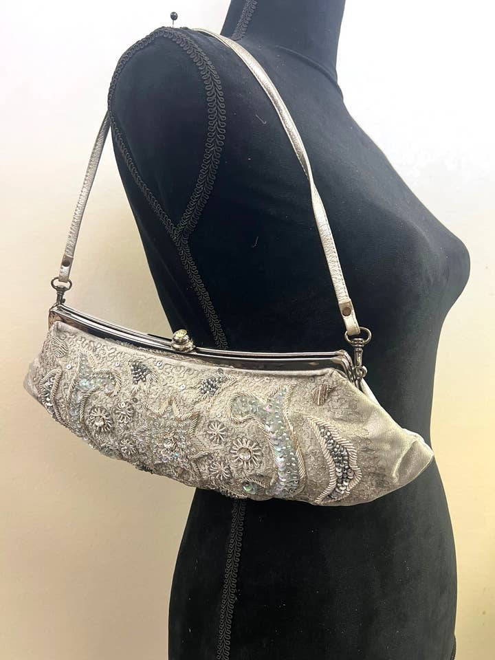 Leather and tissue metal frame floral embroidery clutch for wholesale by Ricki designs