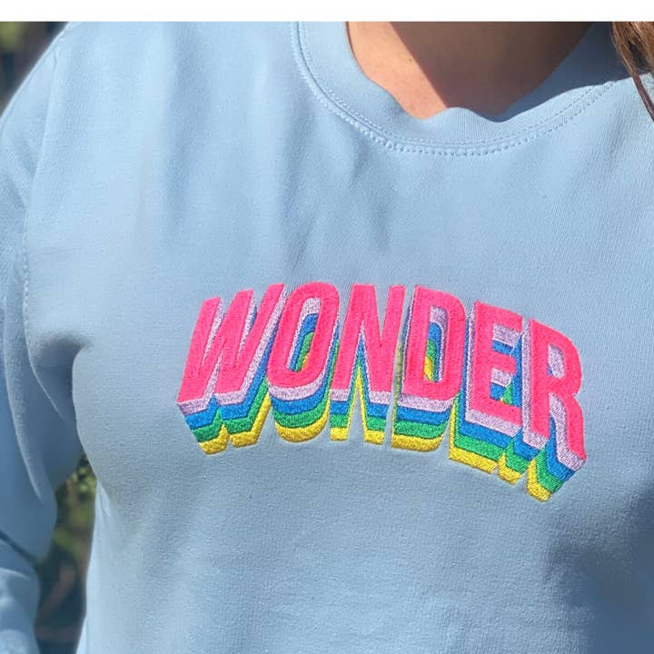 Sweatshirt Wonder bleu bébé avec broderie fluo pour la vente par Percy and Nell Retail Limited