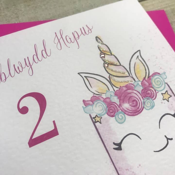 White Cotton Cards - Wholesale Birthday Card - Welsh Age 2 - Unicorn Cake (W-R101-2)1
