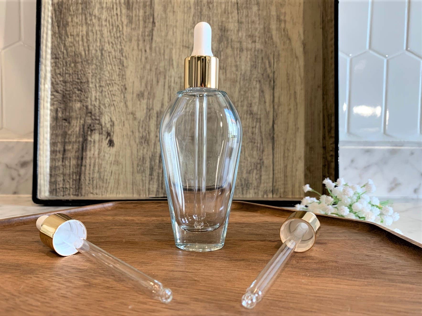 The Bottle Shoppe - Wholesale Essential Oil Holder - 1.7 oz. Tear Drop Clear Glass Bottle with Gold Glass Dropper1