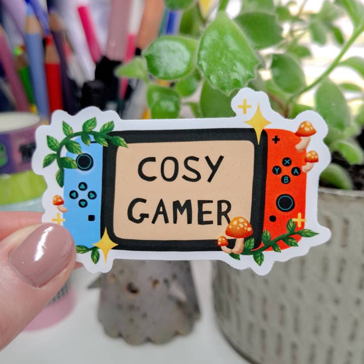 Autocollant de joueur confortable | Rouge, console switch mignonne, jeux vidéo pour la vente par Emily Peet Illustration