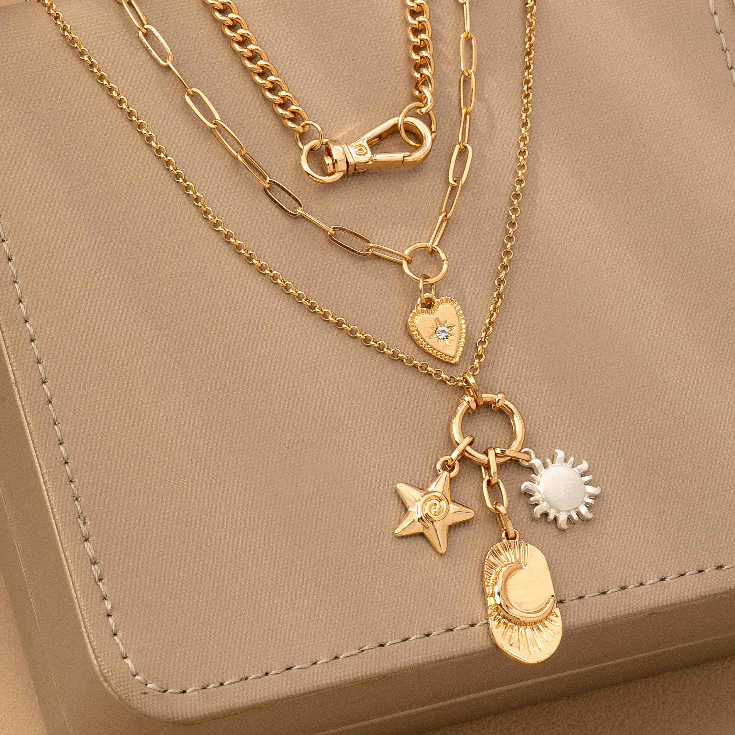 GOLD MULTI LAYER CELESTIAL STAR MOON CHARM NECKLACE | 80N92439 for wholesale on Faire2