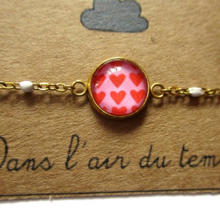 Dans l'Air du Temps Bijoux - Vendita all'ingrosso Braccialetto con ciondolo/pendente - Bracciale Cuore Rosso su sfondo rosa finitura dorata o argentata