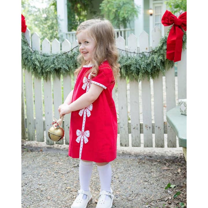 Robe trapèze de Noël à nœuds rouges pour fille pour la vente par Marco and Lizzy