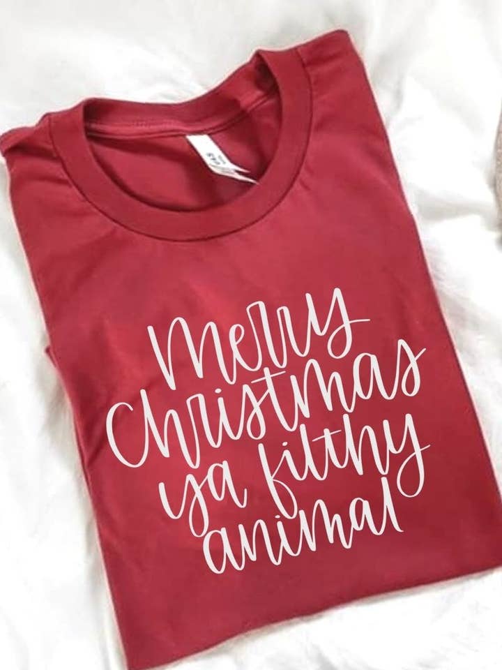 Maglietta con scritta «Merry Christmas Ya sporco animale» per la vendita all'ingrosso da parte di Wilde and Ink Threads