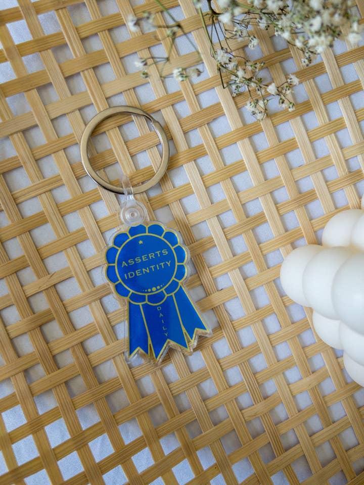 Porte-clés acrylique Asserts Identity Medal pour la vente par Mosaic the Label