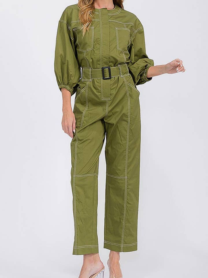 ENSFARVET JUMPSUIT MED LYNGLÅS, BÆLTE OG LOMMER for engroshandel hos ROUSSEAU