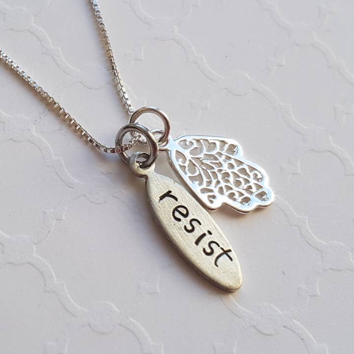 Resist necklace with hamsa charm for wholesale by Resistance Jewelry
