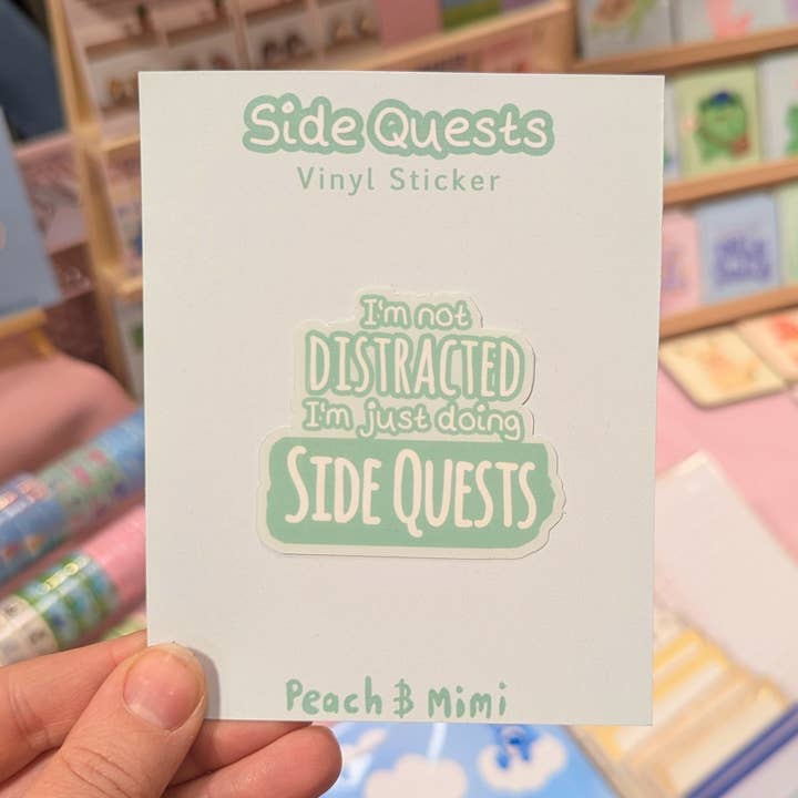 I'm not distracted I'm doing side quests Vinyl Sticker for wholesale by Peach and Mimi
