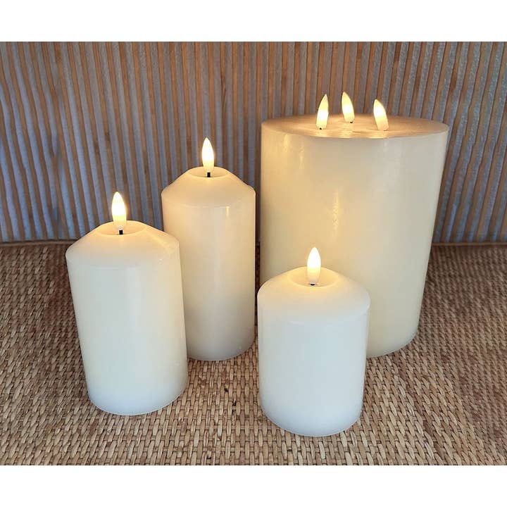 Set of 3 ivory natural wax LED candles with remote control (battery operated) for wholesale on Faire