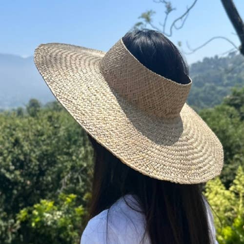 HANDWOVEN NATURAL STRAW CROWNLESS HAT for wholesale on Faire1
