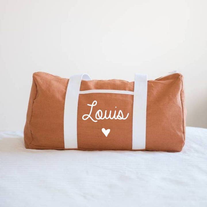Personalized terracotta linen heart symbol weekend bag for wholesale by oh la la paris