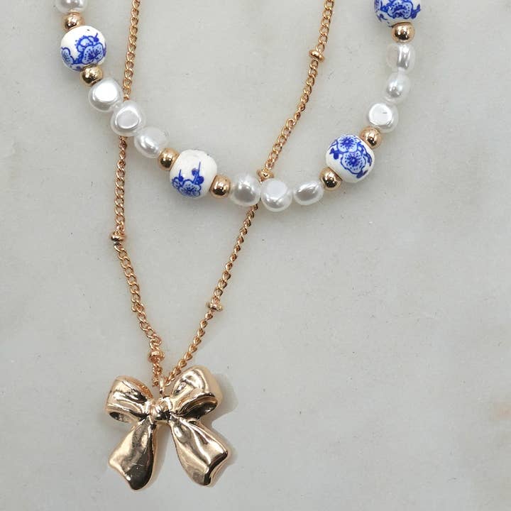 Guld KERAMISK PORCELÆN PERLE BUE LAG HALSKÆDE | 80N91555 for engroshandel på Faire3