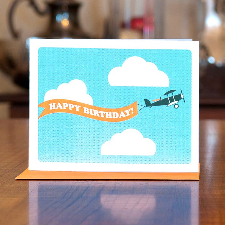 Biplane Banner Birthday Card for wholesale by MAN vs. GEORGE DESIGN