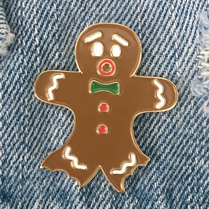 Bitten Gingerbread Man Enamel Pin – Funny Holiday Lapel Pin for wholesale by Little Lovelies Studio
