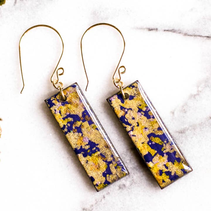 Orecchini Fiocchi Viola E Oro per la vendita all'ingrosso da parte di No Man's Land