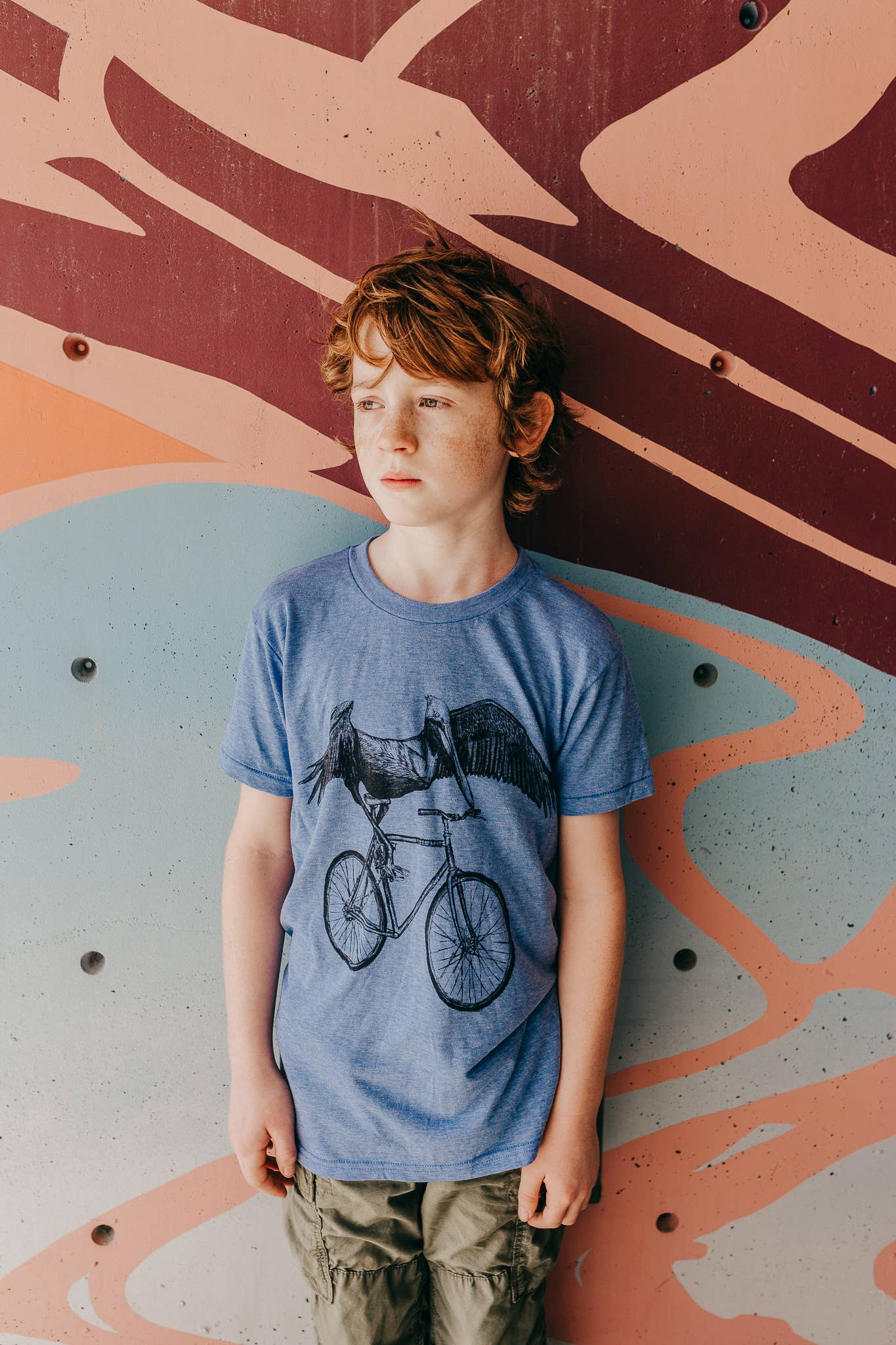 Athletic Blue Pelican On A Bicycle Children's Tee for wholesale on Faire
